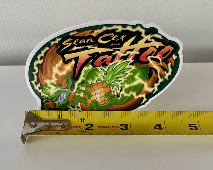 blanka-size-sticker-tattoo-vancouver Blanka pineapple sticker shown beside measuring tape
