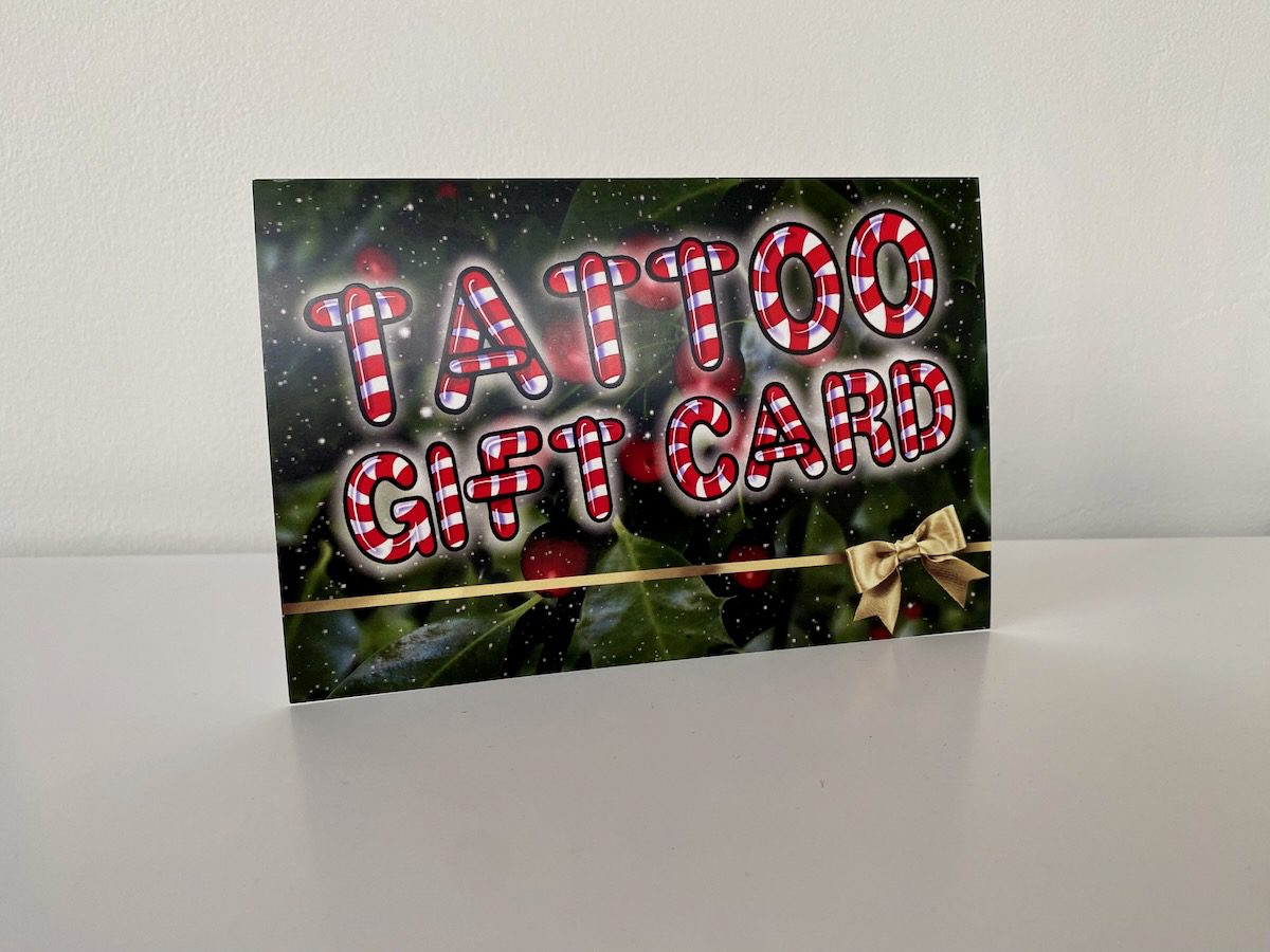christmas-gift-card-tattoo-new-westminster Candy-cane tattoo gift card standing upright.