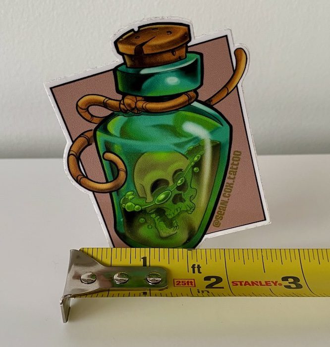 skull-bottle-size-sticker-tattoo-vancouver Skull-in-a-bottle sticker with tape measure