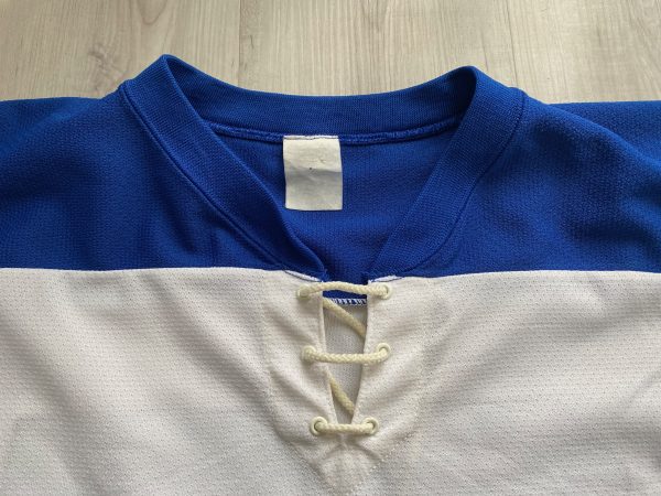 White and blue hockey jersey with “FAIL” maple leaf logo.