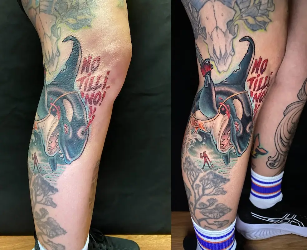 Chainsaw-wielding orca tattoo with protest message