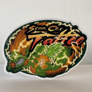 Sticker of Blanka with a pineapple and Sean Cox Tattoo logo