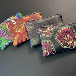 Four vegan-leather stash bags with bold Sean Cox designs.