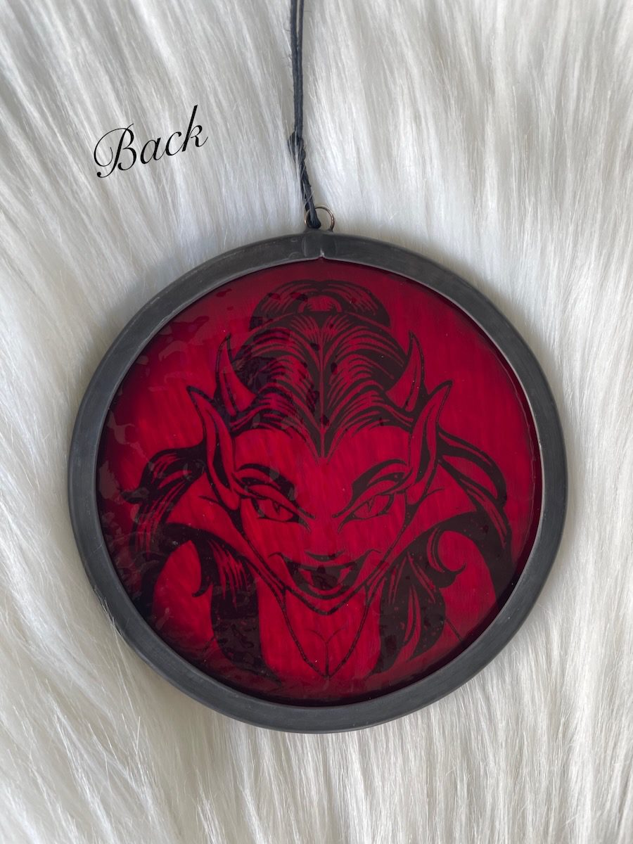 sean-cox-tattoo-glass-art-she-devil-1-back Back of red textured glass round on fur