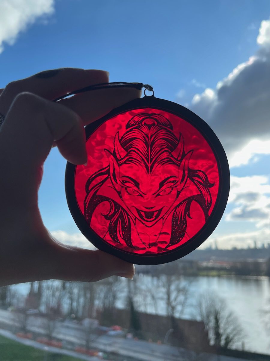 sean-cox-tattoo-glass-art-she-devil-1-front-sky Red devil glass round held against a clear blue sky