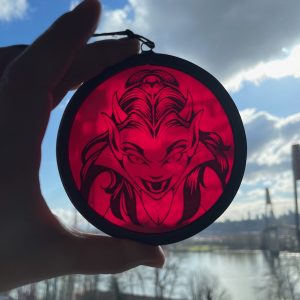 Red devil glass round hanging in front of sky