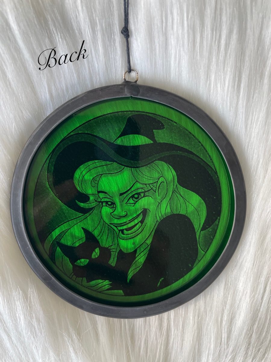 sean-cox-tattoo-glass-art-witch-1-back Back of green witch glass round on fur background