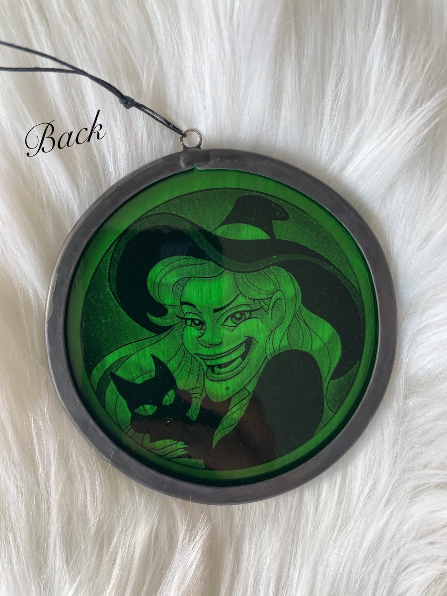 sean-cox-tattoo-glass-art-witch-2-back Back of green witch glass round on fur background