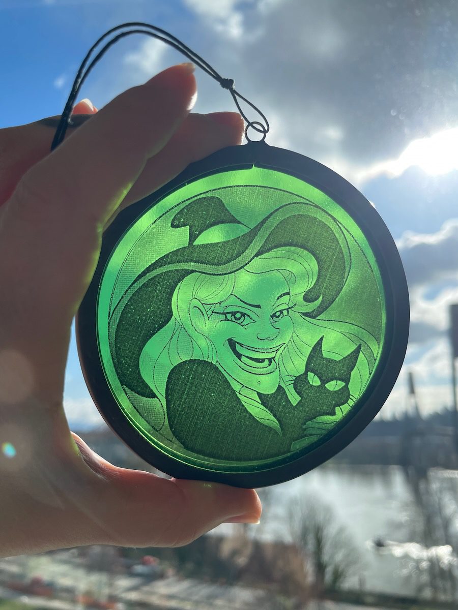 sean-cox-tattoo-glass-art-witch-2-front-sky Green witch glass round held in front of sky